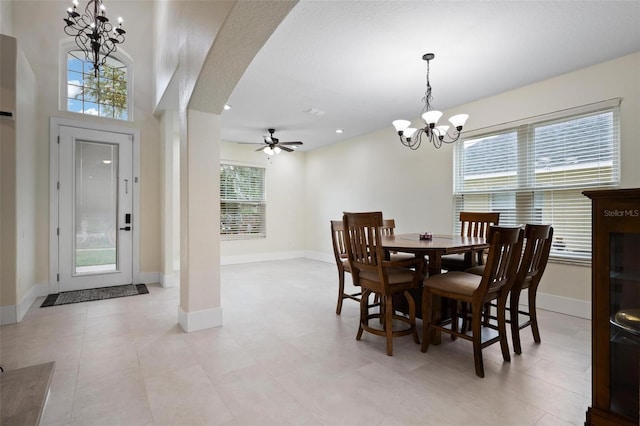 dining room with ceiling fan with notable chandelier