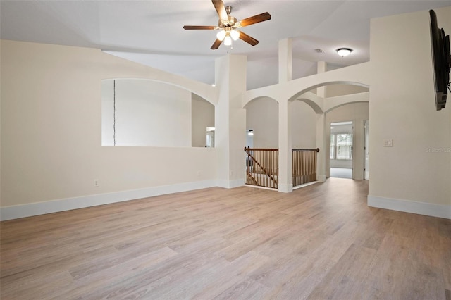 unfurnished room featuring high vaulted ceiling, light hardwood / wood-style flooring, and ceiling fan