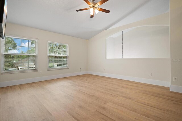 unfurnished room featuring ceiling fan, lofted ceiling, and light wood-type flooring