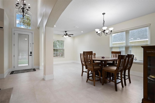 dining room featuring recessed lighting, baseboards, arched walkways, and ceiling fan with notable chandelier