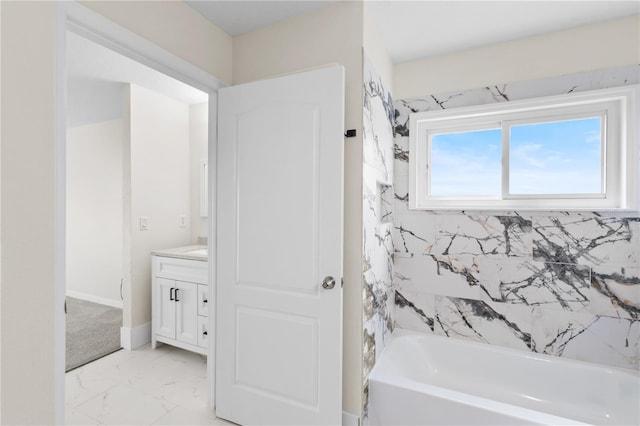 bathroom with shower / washtub combination, marble finish floor, vanity, and baseboards