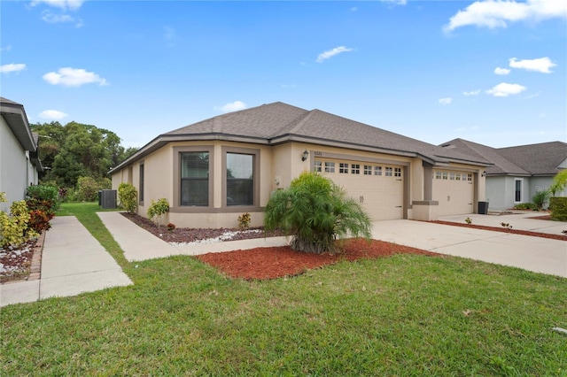 view of front of home with central AC, a garage, and a front lawn