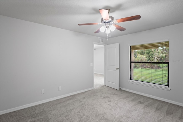 carpeted empty room with ceiling fan