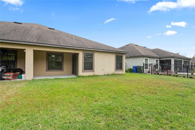 rear view of property with a yard and a patio