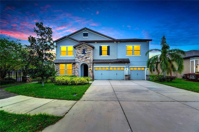 view of front facade featuring a garage and a lawn