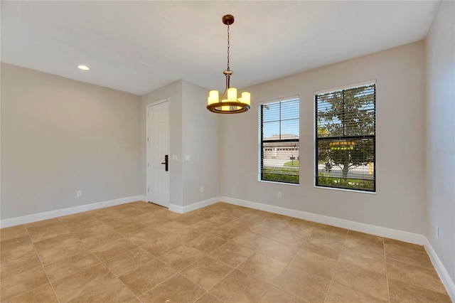 empty room featuring a notable chandelier