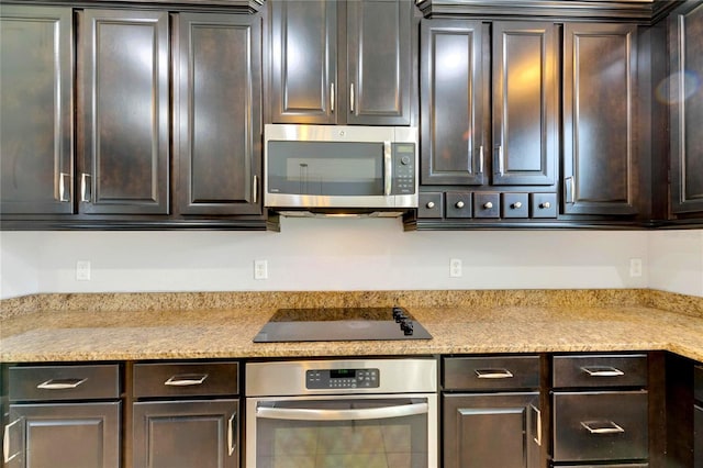 kitchen featuring appliances with stainless steel finishes and dark brown cabinets