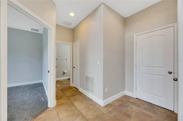 hall featuring light tile patterned floors