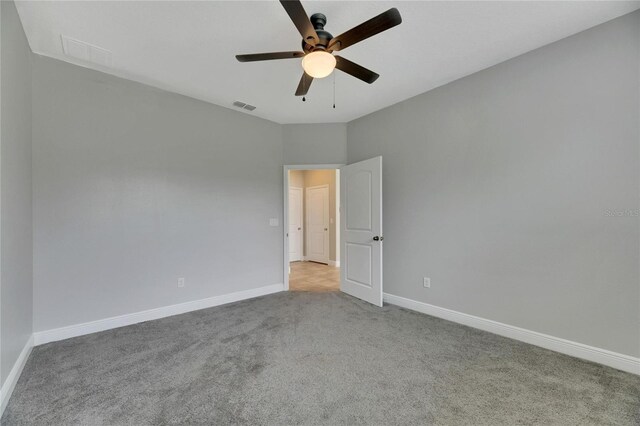 carpeted empty room with ceiling fan