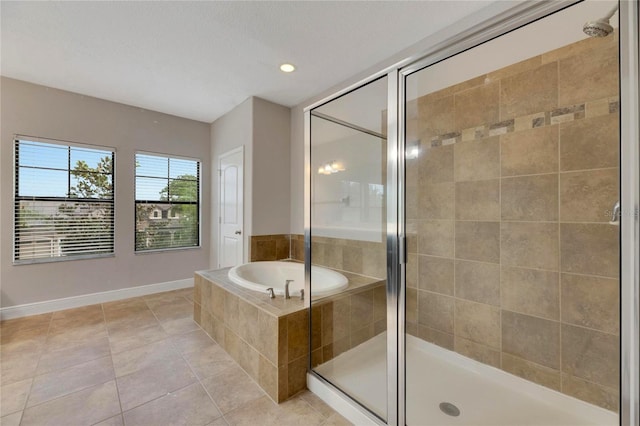 bathroom featuring tile patterned flooring and shower with separate bathtub