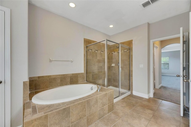 bathroom with tile patterned flooring and separate shower and tub