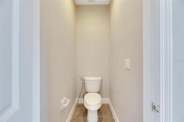 bathroom with tile patterned floors and toilet