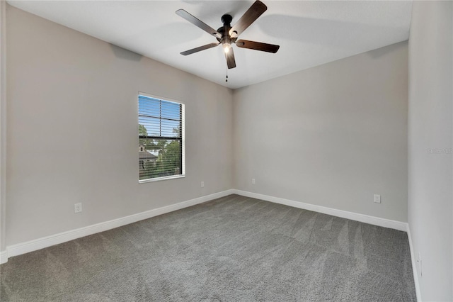 carpeted spare room featuring ceiling fan