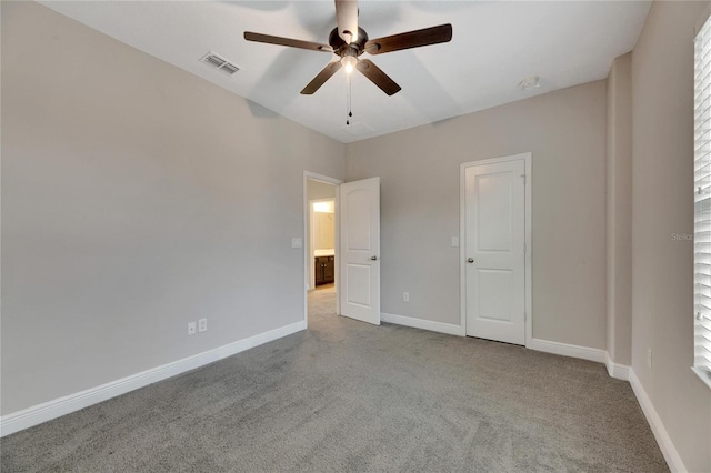 unfurnished bedroom featuring light carpet and ceiling fan