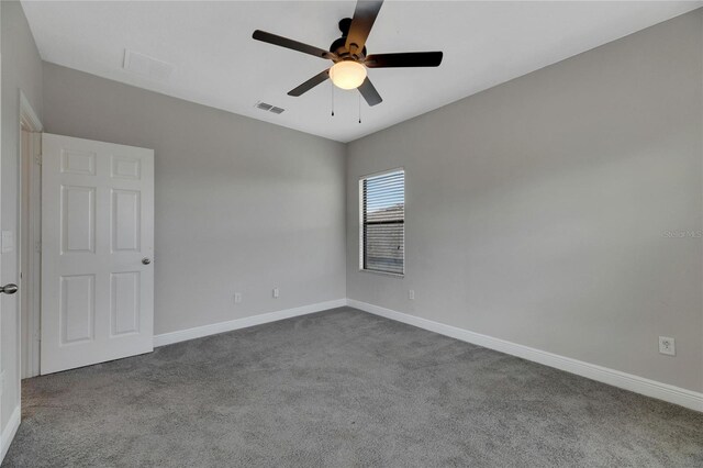 carpeted spare room featuring ceiling fan