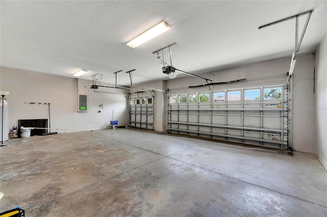 garage featuring electric panel and a garage door opener