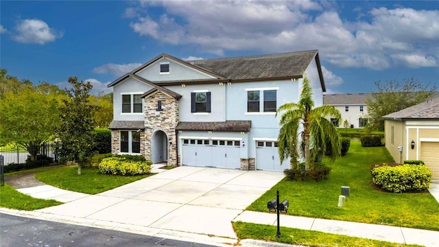 view of front of property with a garage and a front lawn