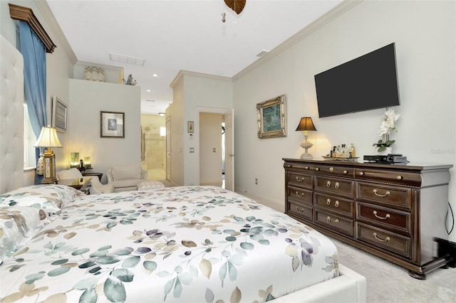 bedroom featuring ceiling fan, light colored carpet, crown molding, and ensuite bath