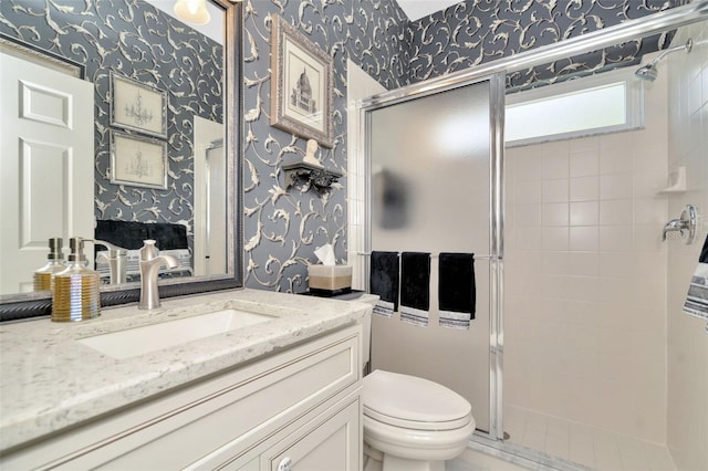 bathroom with vanity, an enclosed shower, and toilet