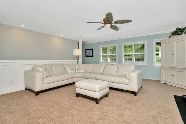 living room featuring ceiling fan, crown molding, and light carpet