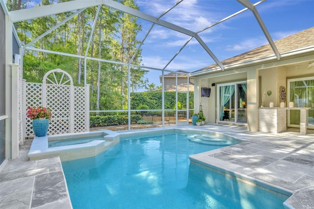 view of swimming pool featuring a lanai, an in ground hot tub, and a patio