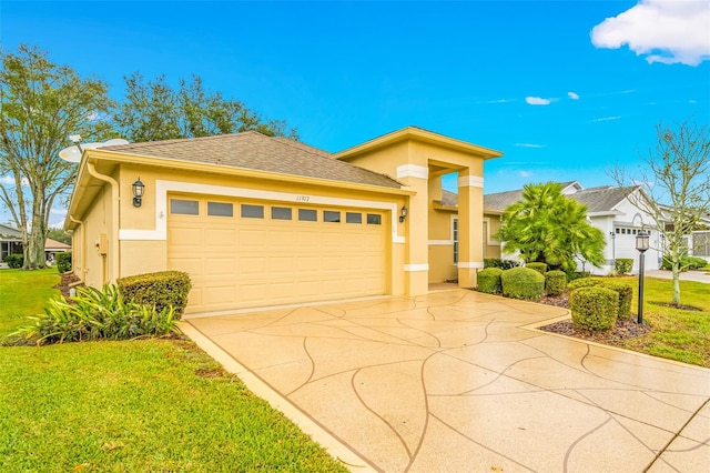 prairie-style home featuring a garage and a front lawn