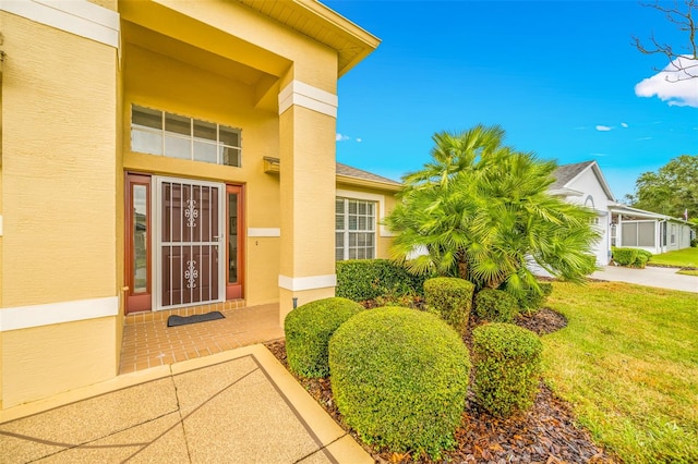 entrance to property with a yard