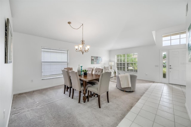 dining room featuring an inviting chandelier and light carpet