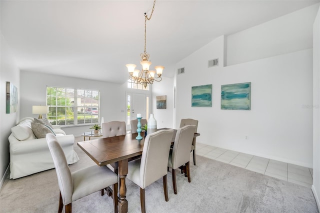 dining area featuring light tile patterned flooring, lofted ceiling, and a chandelier