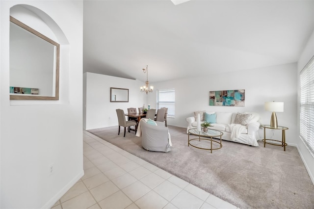 carpeted living room with a chandelier