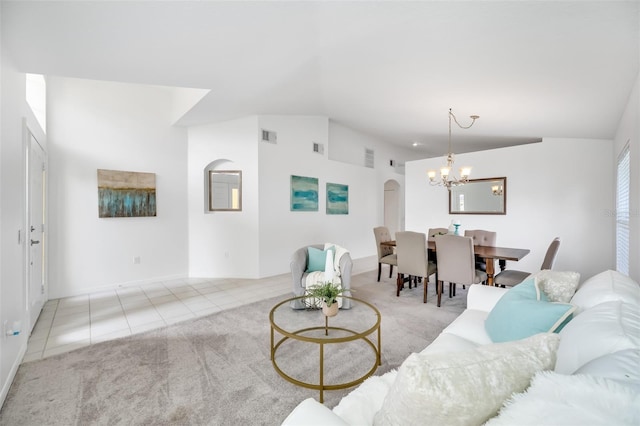 living room with vaulted ceiling, light carpet, and a chandelier