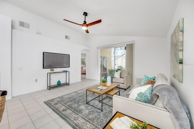 tiled living room with ceiling fan and vaulted ceiling