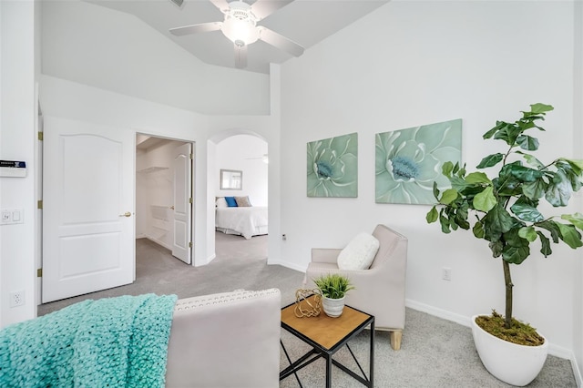 carpeted living room with ceiling fan