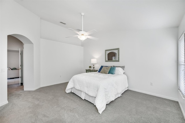 bedroom featuring lofted ceiling, light colored carpet, and ceiling fan