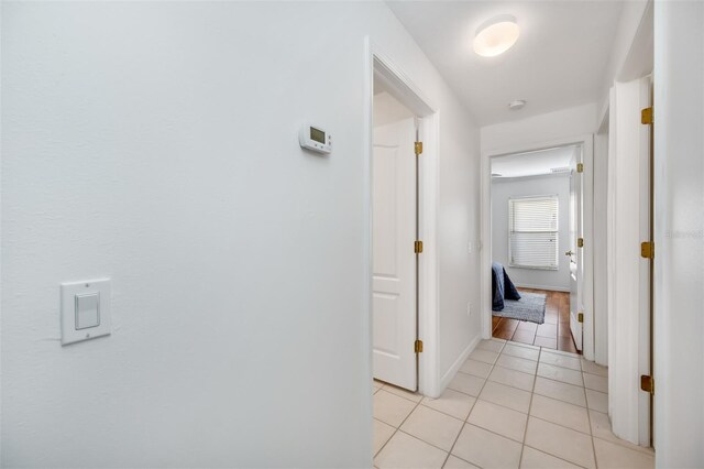 hall featuring light tile patterned floors