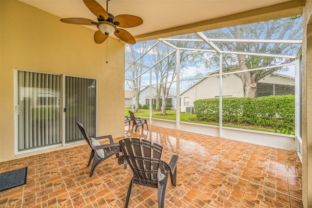 view of patio / terrace featuring a lanai and ceiling fan