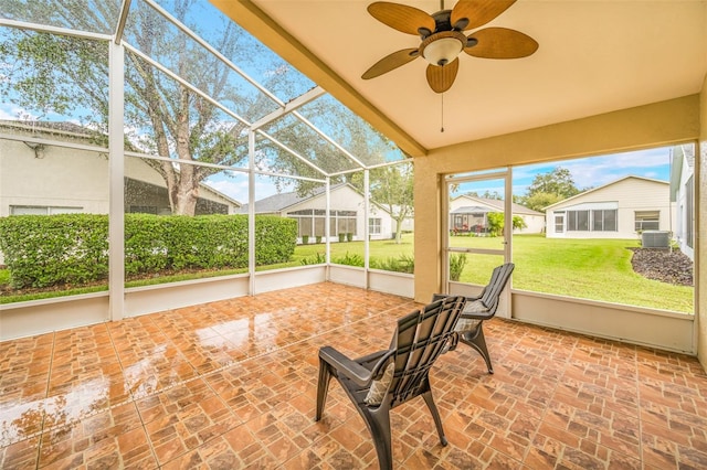 unfurnished sunroom featuring ceiling fan