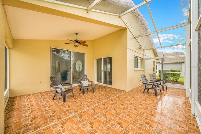 sunroom featuring lofted ceiling and ceiling fan