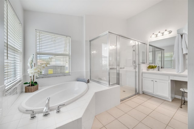 bathroom with tile patterned flooring, vanity, and plus walk in shower