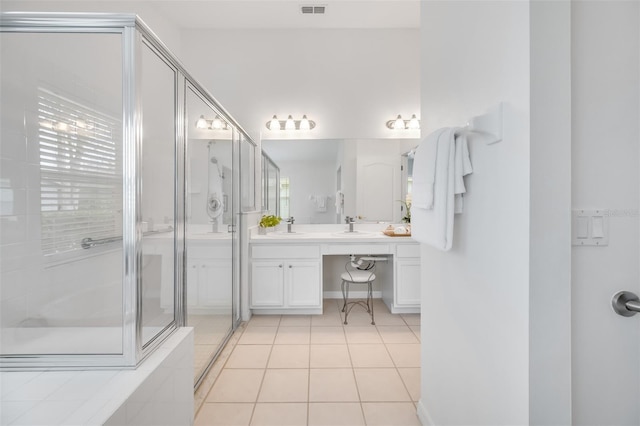 bathroom featuring an enclosed shower, vanity, tile patterned floors, and a healthy amount of sunlight