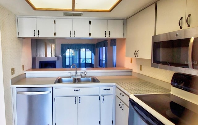 kitchen featuring sink, white cabinets, and stainless steel appliances