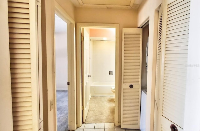 corridor featuring light tile patterned floors