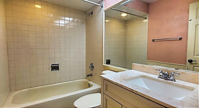 full bathroom with vanity, tiled shower / bath combo, and toilet