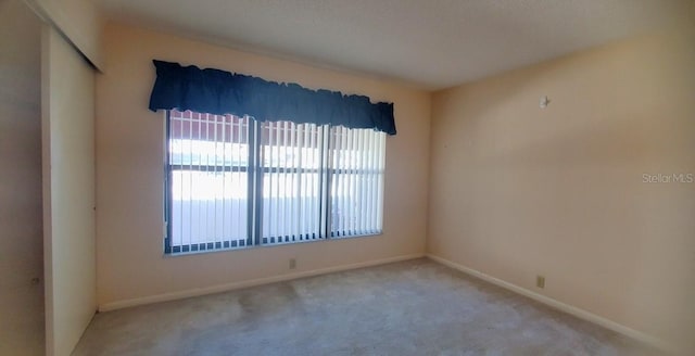 unfurnished room featuring carpet floors