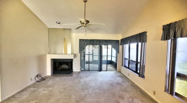 unfurnished living room with carpet, ceiling fan, and vaulted ceiling