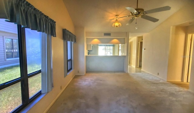 unfurnished room featuring carpet, vaulted ceiling, and ceiling fan