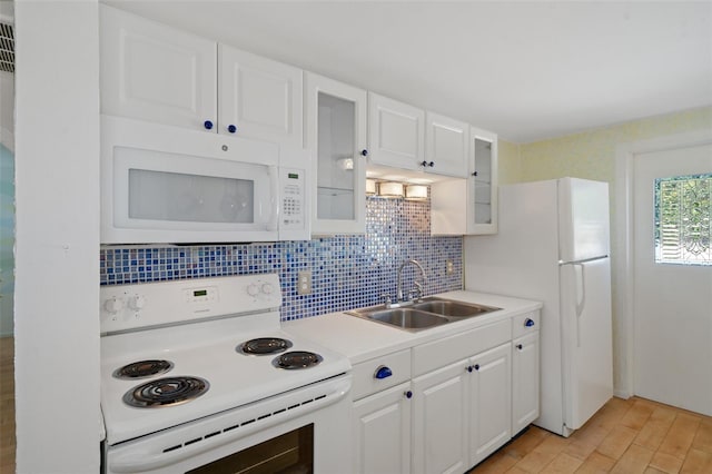 kitchen with white appliances, backsplash, sink, light wood-type flooring, and white cabinetry