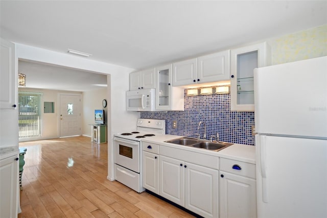 kitchen with sink, tasteful backsplash, light hardwood / wood-style flooring, white appliances, and white cabinets