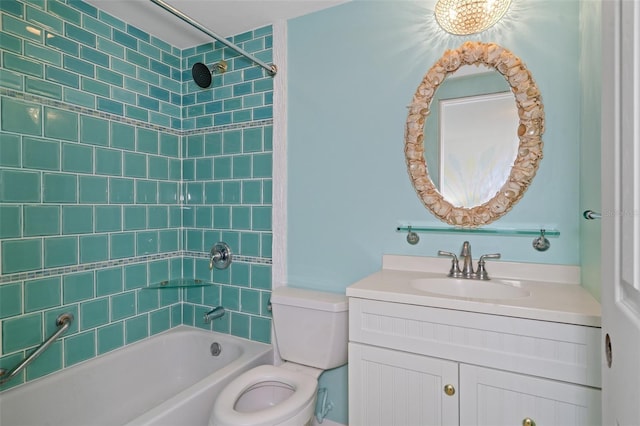 full bathroom featuring tiled shower / bath combo, toilet, and vanity