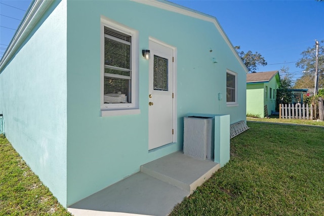 property entrance with a yard